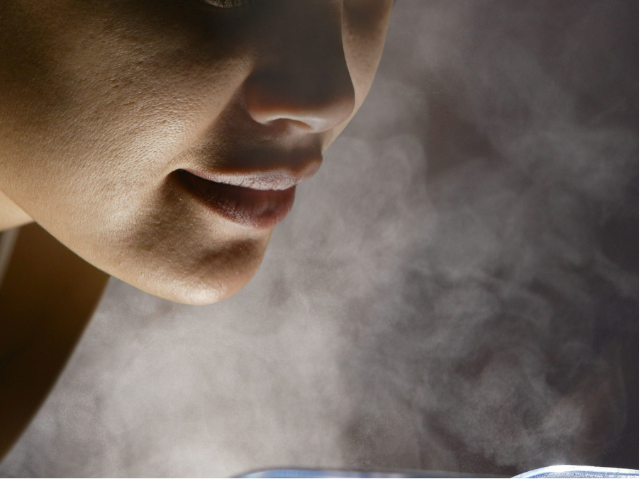 Woman Doing Inhalation Herbal Medicine Using Steam Bowl